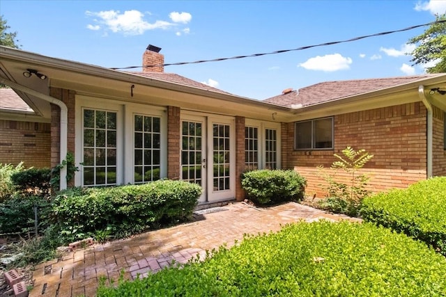 1506 Ridgeview Dr, Arlington, TX 76012 - rear view of house with a chimney, french doors, brick siding, and a shingled roof