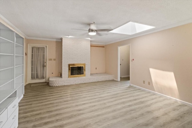 1506 Ridgeview Dr, Arlington, TX 76012 - unfurnished living room featuring a skylight, a ceiling fan, ornamental molding, wood finished floors, and a textured ceiling