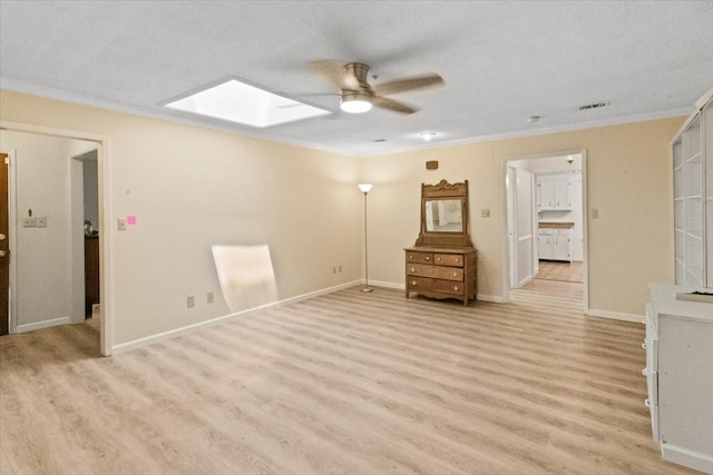 1506 Ridgeview Dr, Arlington, TX 76012 - unfurnished living room featuring a skylight, light wood-style flooring, ceiling fan, crown molding, and baseboards