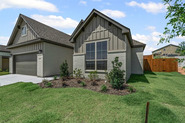 207 Mitchell Dr, Glen Rose, TX 76043 - view of side of home featuring board and batten siding, brick siding, a shingled roof, concrete driveway, and a garage