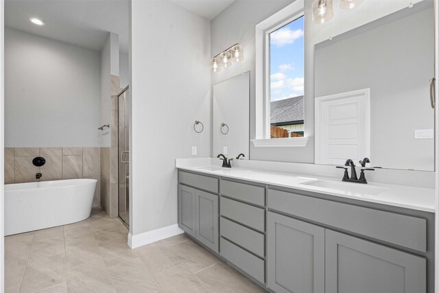 207 Mitchell Dr, Glen Rose, TX 76043 - full bathroom with double vanity, a freestanding bath, and a shower stall