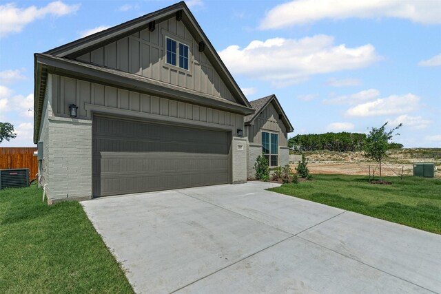 207 Mitchell Dr, Glen Rose, TX 76043 - view of front of house with board and batten siding, driveway, and brick siding
