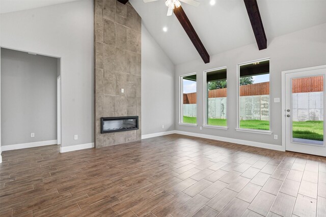 207 Mitchell Dr, Glen Rose, TX 76043 - unfurnished living room featuring high vaulted ceiling, ceiling fan, beam ceiling, wood finished floors, and recessed lighting