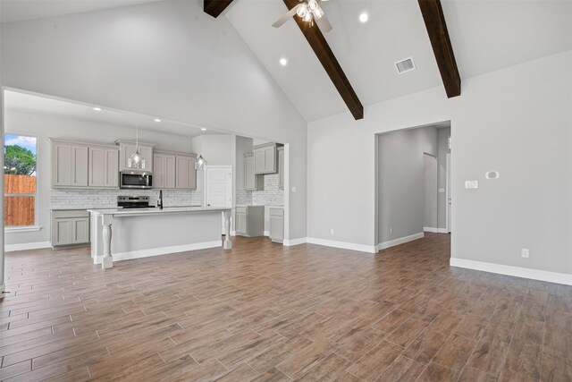 207 Mitchell Dr, Glen Rose, TX 76043 - unfurnished living room with beamed ceiling, recessed lighting, a ceiling fan, light wood finished floors, and high vaulted ceiling