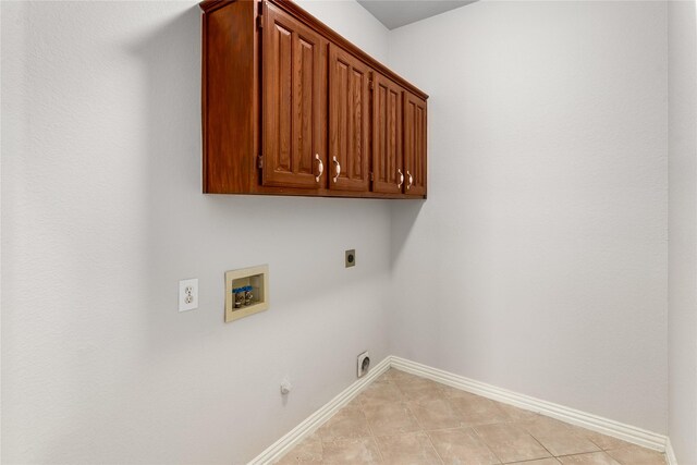 3616 Canyon Oaks Dr, Carrollton, TX 75007 - washroom featuring electric dryer hookup, washer hookup, cabinet space, gas dryer hookup, and light tile patterned floors