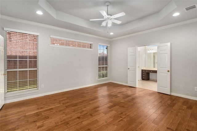 3616 Canyon Oaks Dr, Carrollton, TX 75007 - unfurnished bedroom featuring a tray ceiling, wood finished floors, ornamental molding, ensuite bathroom, and recessed lighting