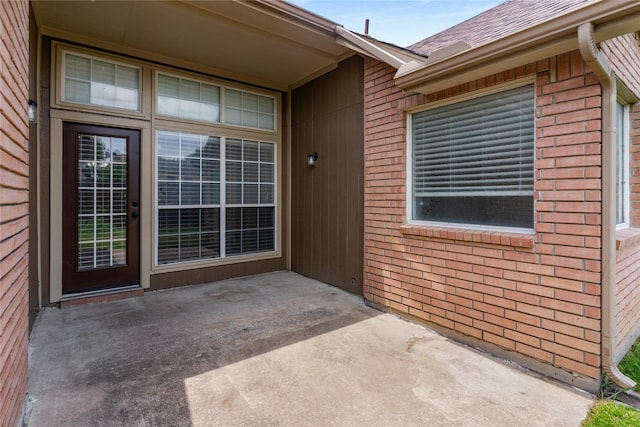 3616 Canyon Oaks Dr, Carrollton, TX 75007 - entrance to property featuring brick siding, a patio area, and a shingled roof
