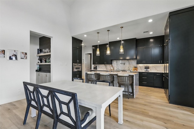 5901 Westworth Falls Way, Westworth Village, TX 76114 - dining space featuring light wood-style floors, recessed lighting, bar, baseboards, and a towering ceiling