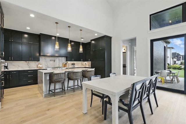 5901 Westworth Falls Way, Westworth Village, TX 76114 - dining room featuring light wood-style floors, recessed lighting, and a towering ceiling