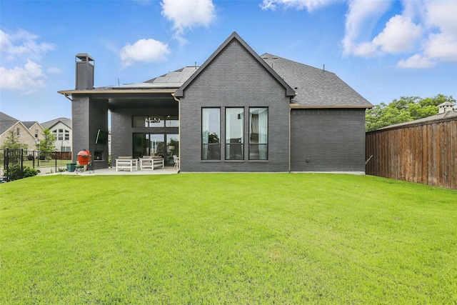5901 Westworth Falls Way, Westworth Village, TX 76114 - back of house featuring a chimney, a patio, brick siding, solar panels, and a shingled roof