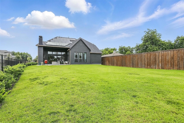 5901 Westworth Falls Way, Westworth Village, TX 76114 - rear view of house with roof mounted solar panels, a chimney, and a sunroom