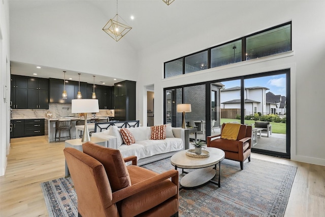 5901 Westworth Falls Way, Westworth Village, TX 76114 - living area with light wood finished floors, a towering ceiling, and baseboards