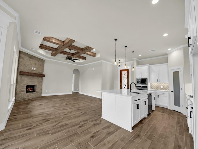 971 County Road 1304, Bridgeport, TX 76426 - kitchen with appliances with stainless steel finishes, light wood-type flooring, arched walkways, ornamental molding, and a ceiling fan