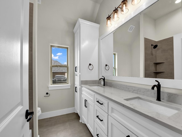 971 County Road 1304, Bridgeport, TX 76426 - full bathroom featuring double vanity, toilet, tiled shower, and baseboards