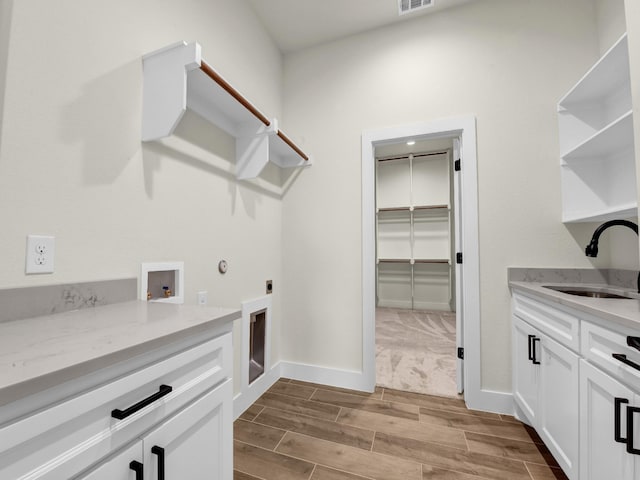 971 County Road 1304, Bridgeport, TX 76426 - washroom featuring cabinet space, wood finished floors, hookup for an electric dryer, and washer hookup