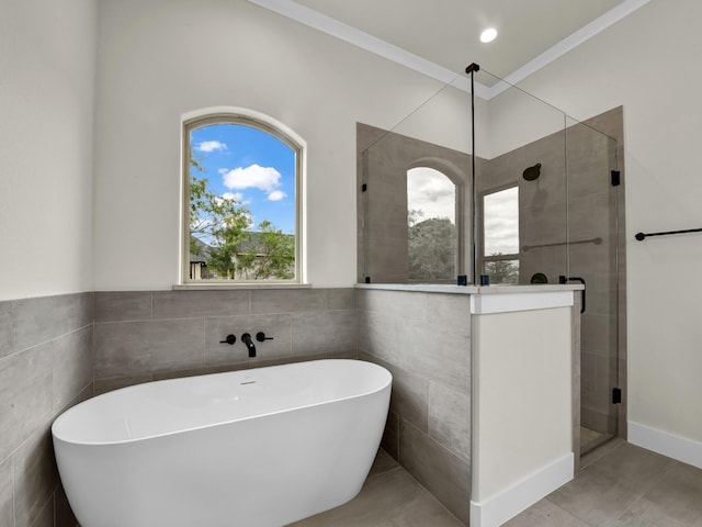 971 County Road 1304, Bridgeport, TX 76426 - bathroom featuring a freestanding tub, a shower stall, tile patterned floors, tile walls, and ornamental molding