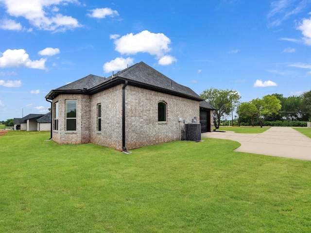 971 County Road 1304, Bridgeport, TX 76426 - view of side of property featuring driveway, cooling unit, a yard, a garage, and brick siding