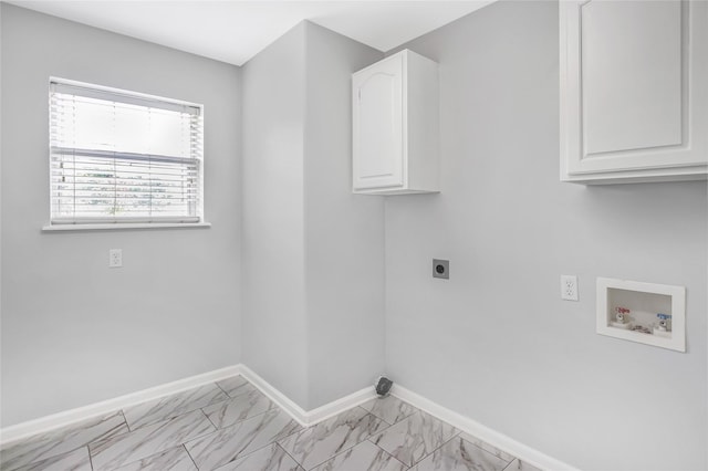 5718 Gloucester Dr, Tyler, TX 75707 - laundry room featuring washer hookup, cabinet space, electric dryer hookup, light marble finish flooring, and baseboards