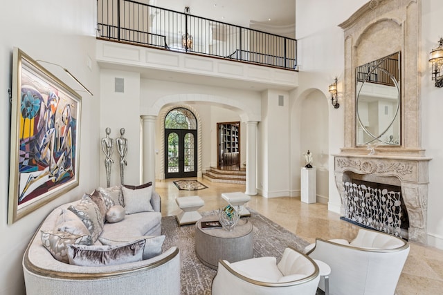5112 Palomar Ln, Dallas, TX 75229 - living area featuring arched walkways, ornate columns, a high ceiling, baseboards, and french doors