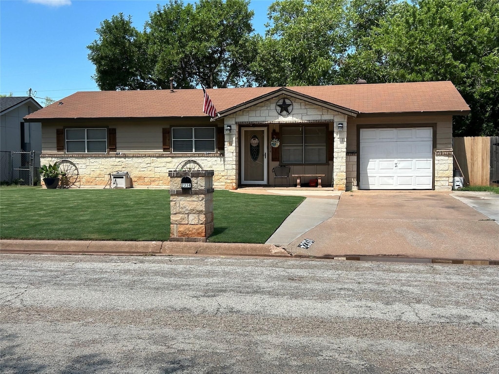 2334 Glendale Dr, Abilene, TX 79603 - ranch-style house with stone siding, an attached garage, driveway, and roof with shingles