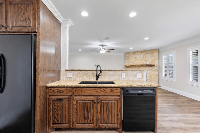 1458 Foxwood Ln, Rockwall, TX 75032 - kitchen with black appliances, a sink, decorative backsplash, crown molding, and light wood-style floors