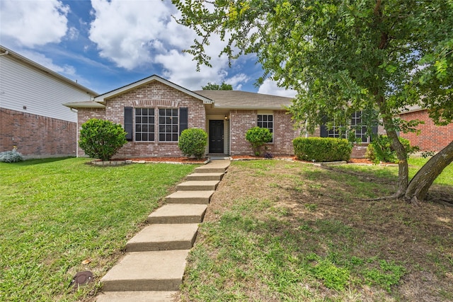 1458 Foxwood Ln, Rockwall, TX 75032 - ranch-style house with brick siding and a front yard