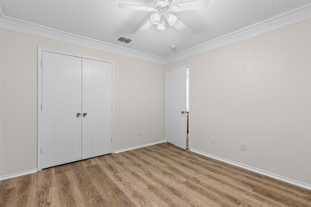1458 Foxwood Ln, Rockwall, TX 75032 - unfurnished bedroom featuring wood finished floors, a textured ceiling, ornamental molding, baseboards, and ceiling fan