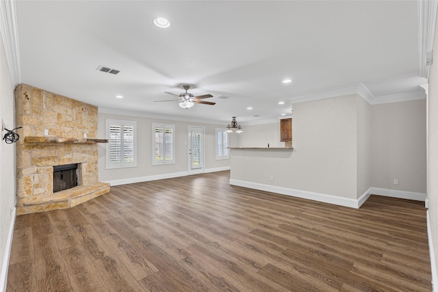 1458 Foxwood Ln, Rockwall, TX 75032 - unfurnished living room featuring crown molding, a stone fireplace, baseboards, ceiling fan, and dark wood finished floors