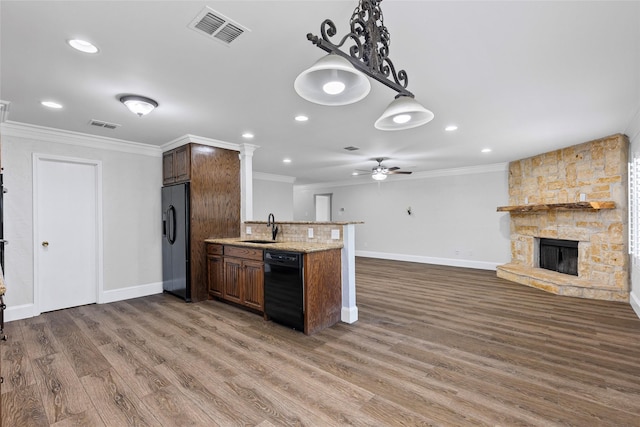 1458 Foxwood Ln, Rockwall, TX 75032 - kitchen featuring black appliances, a sink, crown molding, ceiling fan, and a fireplace