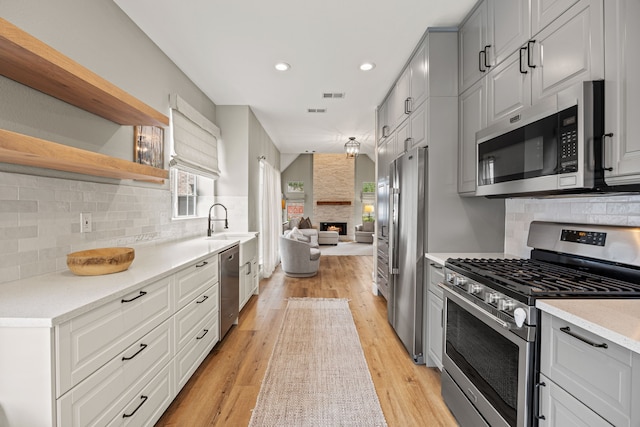 8620 Quail Meadow Dr, Irving, TX 75063 - kitchen featuring stainless steel appliances, healthy amount of natural light, open floor plan, recessed lighting, and light wood finished floors