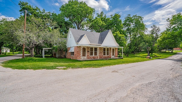 224 Pecan St, Dublin, TX 76446 - view of front of home featuring brick siding, a front lawn, roof with shingles, and a porch