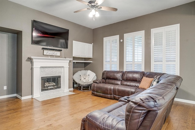 12225 Vienna Apple Rd, Fort Worth, TX 76244 - living area with a ceiling fan, light wood-type flooring, and a tiled fireplace