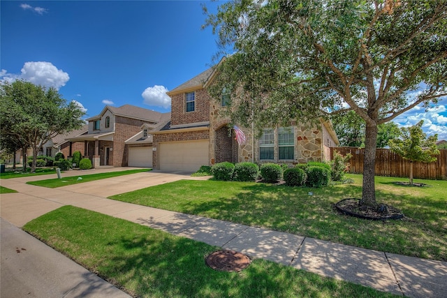 189 Charleston Ln, Fate, TX 75189 - view of front of property featuring an attached garage, brick siding, driveway, and stone siding