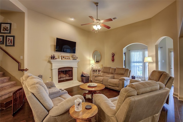 189 Charleston Ln, Fate, TX 75189 - living area with a ceiling fan, a fireplace with raised hearth, and dark wood-style flooring