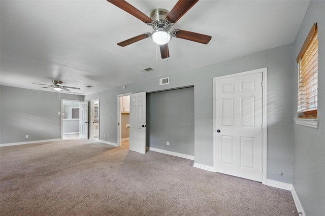 1700 N Preston St, Ennis, TX 75119 - unfurnished bedroom with light carpet, ceiling fan, and ensuite bath