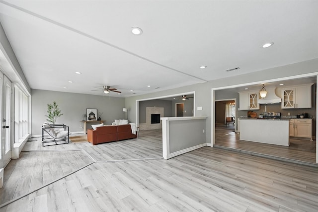 1700 N Preston St, Ennis, TX 75119 - living area featuring a ceiling fan, healthy amount of natural light, recessed lighting, and light wood finished floors