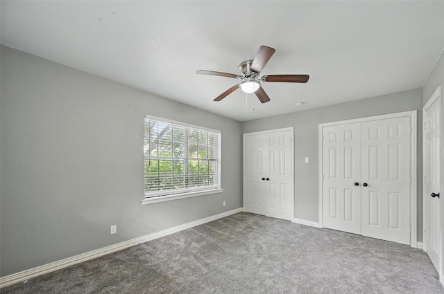 1700 N Preston St, Ennis, TX 75119 - unfurnished bedroom featuring multiple closets, carpet flooring, and ceiling fan