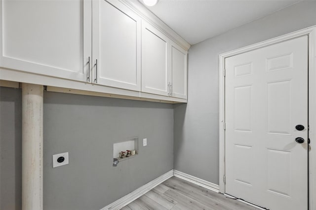 1700 N Preston St, Ennis, TX 75119 - laundry room with hookup for an electric dryer, cabinet space, hookup for a washing machine, and light wood finished floors