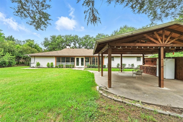 1700 N Preston St, Ennis, TX 75119 - back of house with french doors, a yard, and a patio area