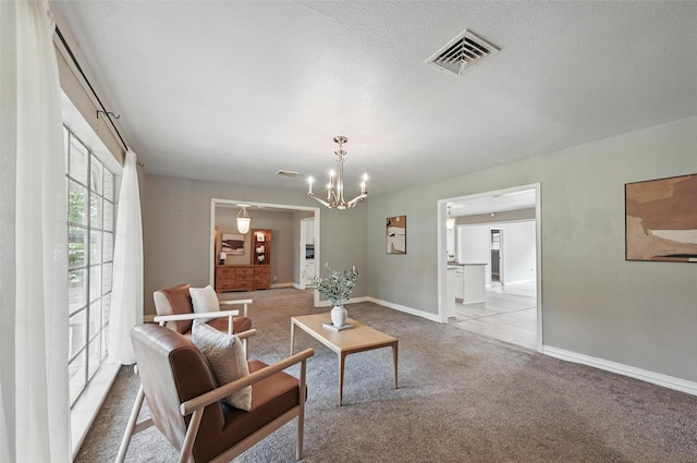 1700 N Preston St, Ennis, TX 75119 - living room featuring carpet and a chandelier