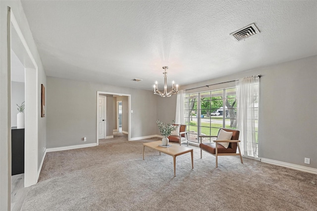 1700 N Preston St, Ennis, TX 75119 - sitting room featuring carpet flooring, a chandelier, and a textured ceiling
