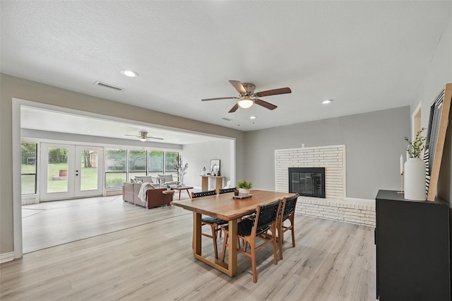 1700 N Preston St, Ennis, TX 75119 - dining area featuring light wood-style flooring, a ceiling fan, a fireplace, french doors, and recessed lighting