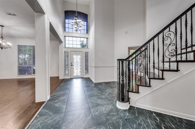 3612 Waynoka Dr, Carrollton, TX 75007 - entryway featuring a chandelier, marble tiled flooring, baseboards, a towering ceiling, and ornamental molding