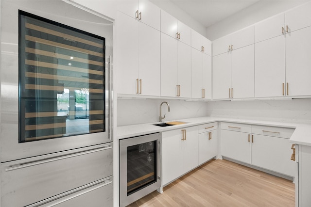 1106 Knoll Crest Dr, Mansfield, TX 76063 - kitchen with wine cooler, a sink, light countertops, and a warming drawer