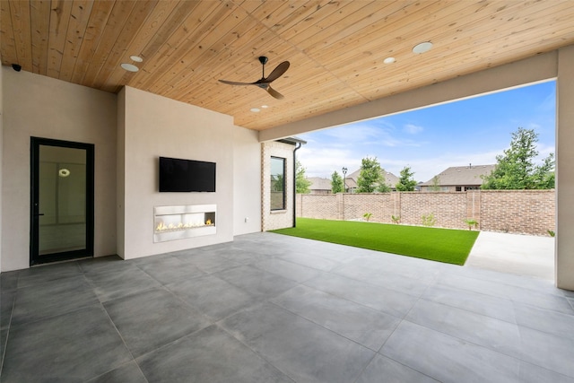 1106 Knoll Crest Dr, Mansfield, TX 76063 - view of patio with a ceiling fan and a lit fireplace