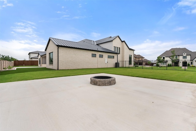 1106 Knoll Crest Dr, Mansfield, TX 76063 - rear view of property featuring an outdoor fire pit, a standing seam roof, a patio, and metal roof