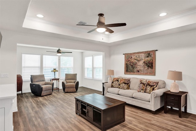 7668 Monument Dr, Little Elm, TX 76227 - living area with ceiling fan, a tray ceiling, ornamental molding, wood finished floors, and recessed lighting