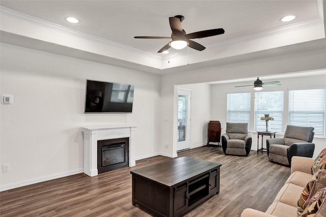 7668 Monument Dr, Little Elm, TX 76227 - living room featuring ceiling fan, ornamental molding, dark wood-style floors, recessed lighting, and a glass covered fireplace