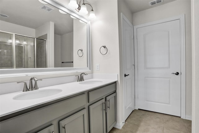 7668 Monument Dr, Little Elm, TX 76227 - full bath featuring double vanity, tile patterned floors, and a shower with shower door