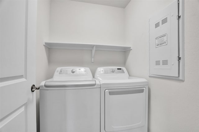 7668 Monument Dr, Little Elm, TX 76227 - laundry area with washing machine and clothes dryer and electric panel
